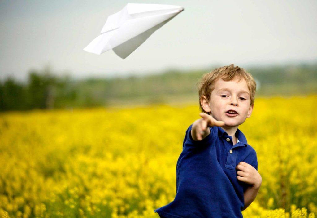 Boy Throwing Paper Aeroplane