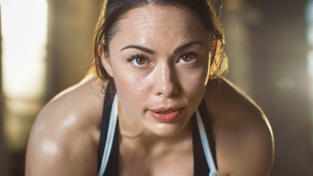 Woman Staring Into Camera After Training Hard