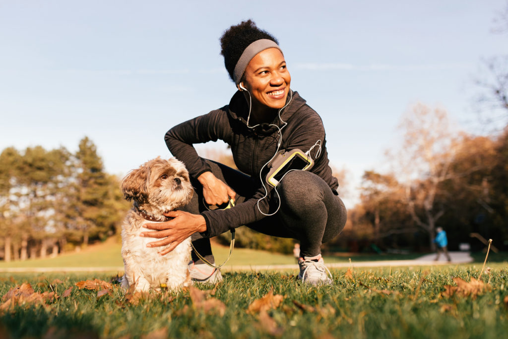 Healthy Woman With Cute Dog In Park
